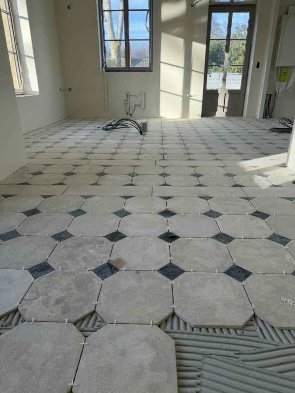 Pose de carrelage au sol en octogones avec cabochons blancs et noir par des carreleurs qualifiés proche de Rouen 76 - TK Carrelage